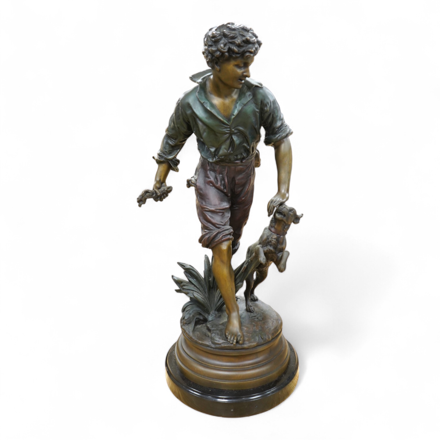 A large painted spelter model of a boy with a dog, on stand - 68cm high